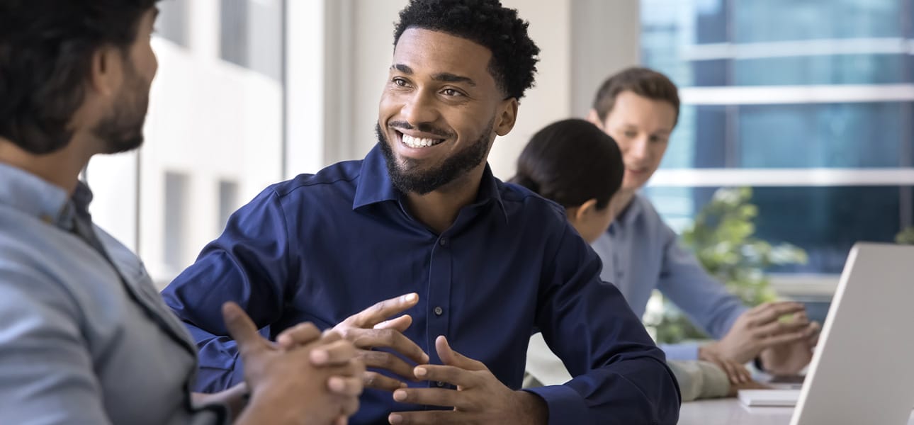 Positive African project manger man meeting with male Indian colleague