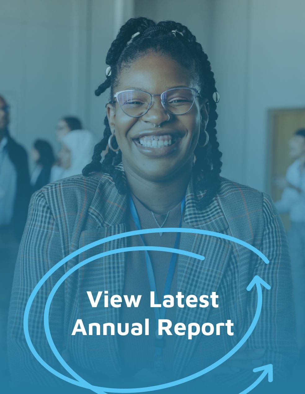 Woman wearing glasses and a plaid blazer smiles; 