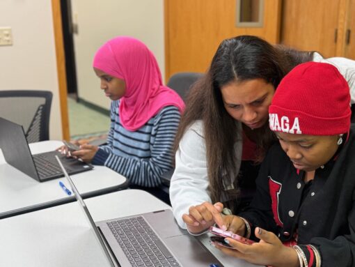 Teacher helping student on phone
